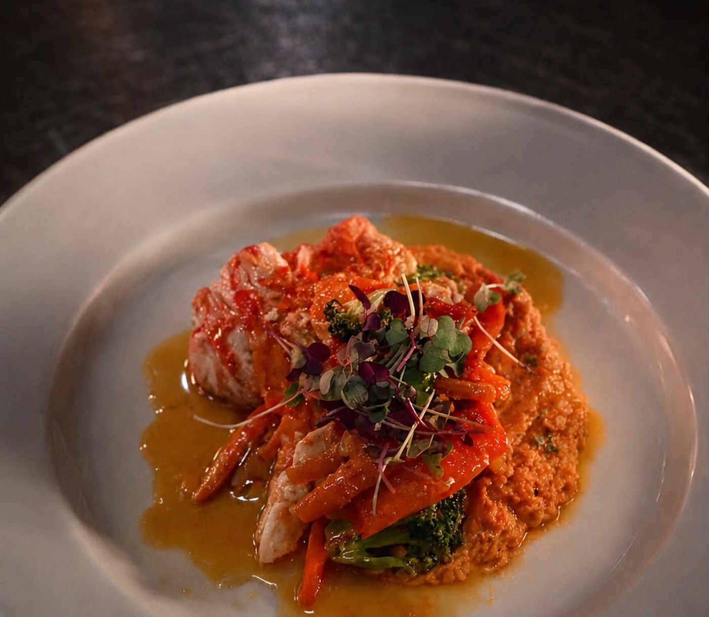 Butter-poached lobster over sweet potato with sweet peppers and broccoli