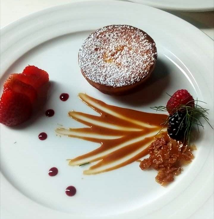 Warm dessert tart with berries and caramel detailing