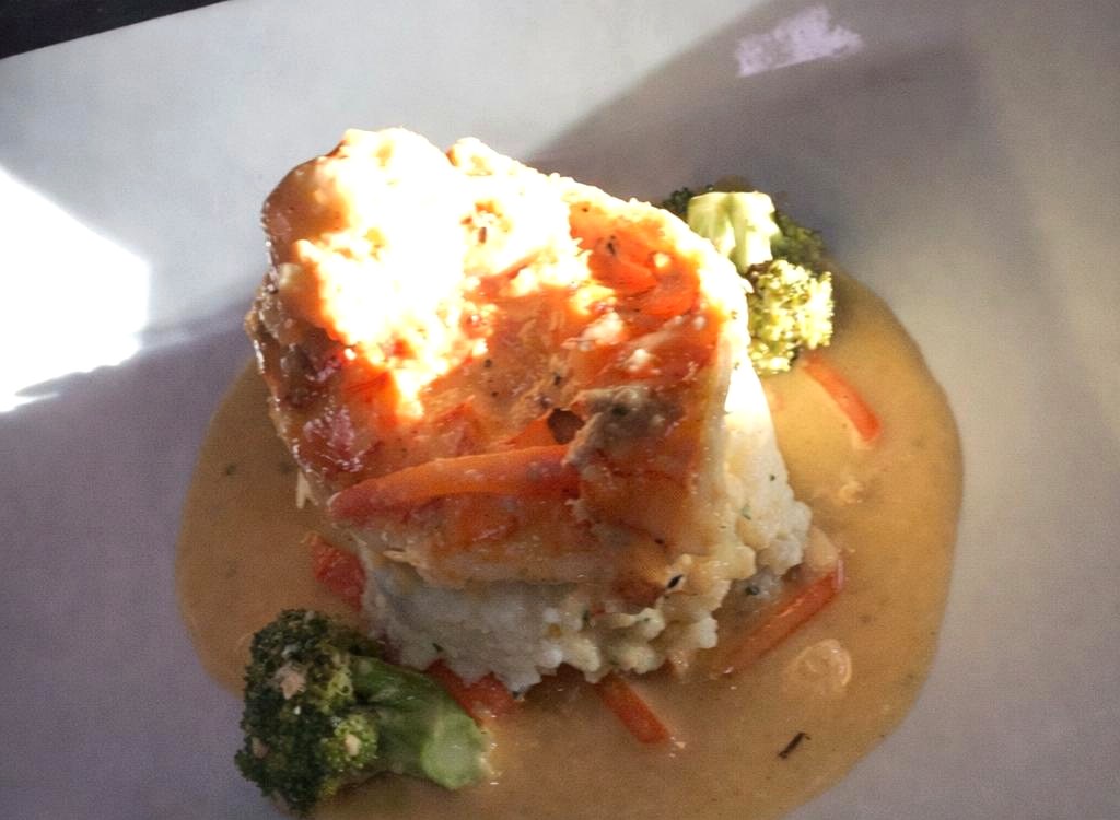 Butter-poached lobster over smashed potatoes with garden vegetables
