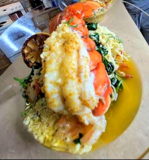 Lobster and shrimp platter with charred lemon and greens