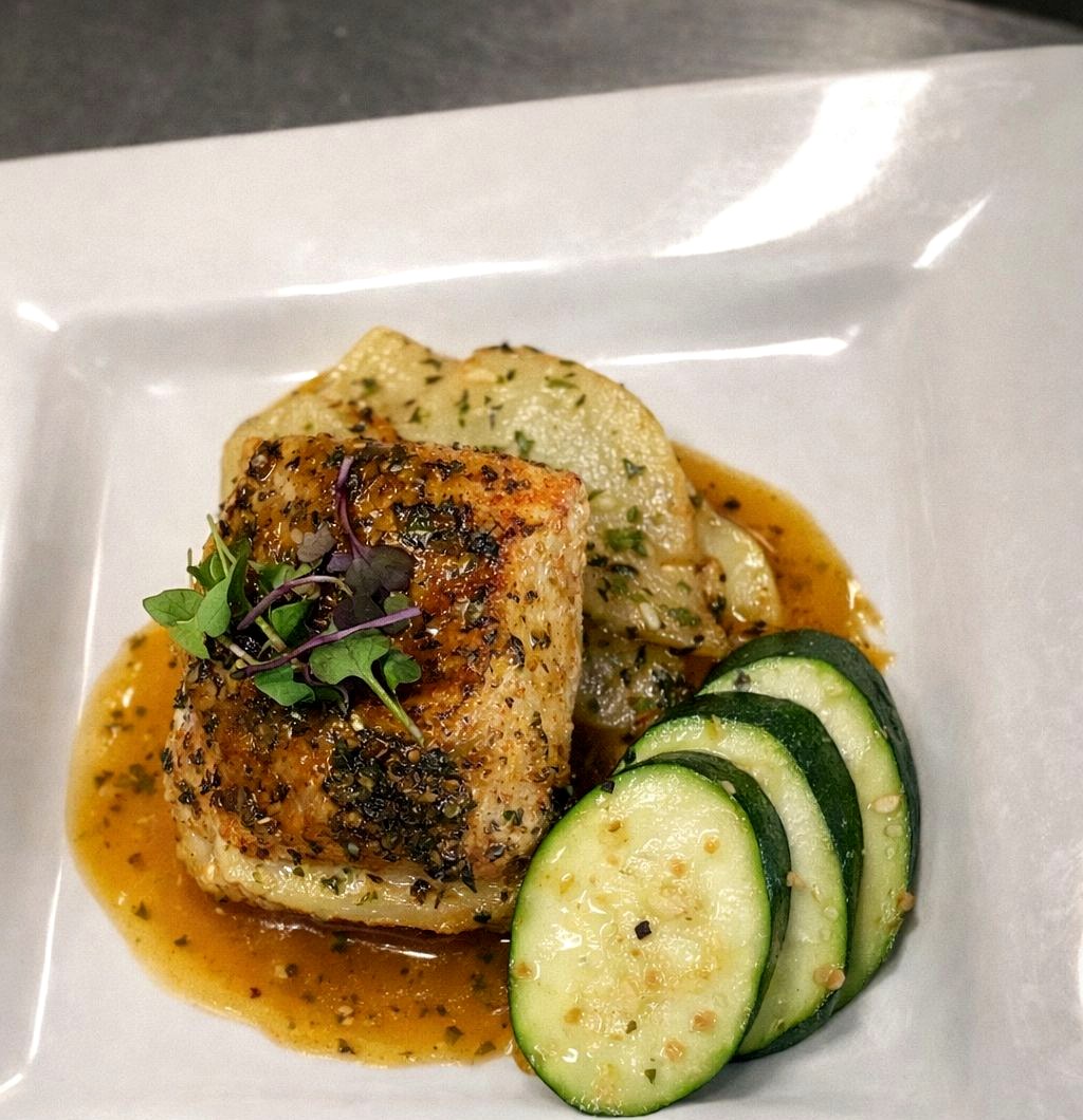 Lemon butter mutton snapper over herb Lyonnaise potatoes, plated by Chef Stacy